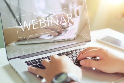 Businessman working on his laptop with webinar website on his co